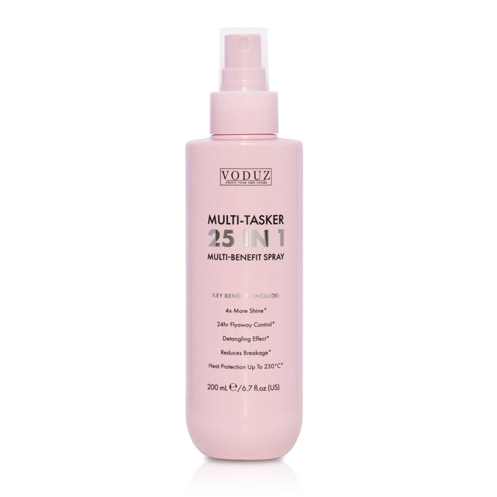 A bottle of VODUZ Multi-Tasker 25 In 1 Multi-Benefit Spray in a soft pastel pink color, shown on a clean white background with a subtle reflection.