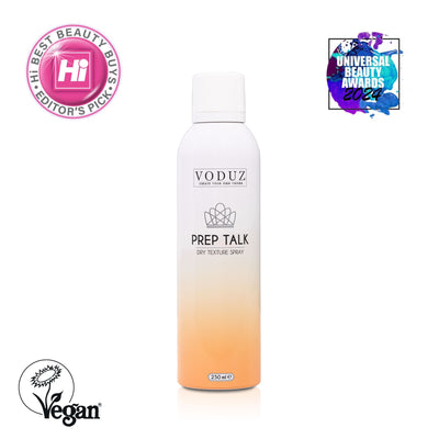 A can of Voduz Prep Talk Dry Texture Spray with a white and orange design, indicating a volume of 250ml. Award labels "Universal Beauty Awards 2024" and "Hi Best Beauty Buys - Editor Picks" and Vegan Society Logo.