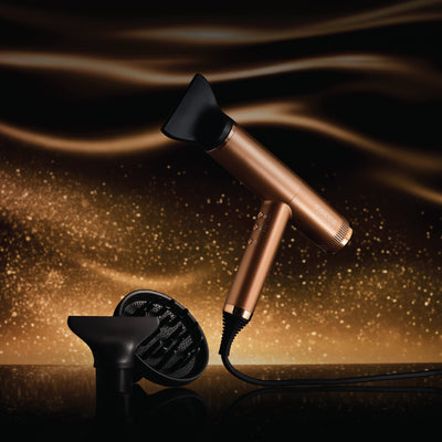 Bronze Voduz Blow Out Pro hair dryer with packaging on a dark background